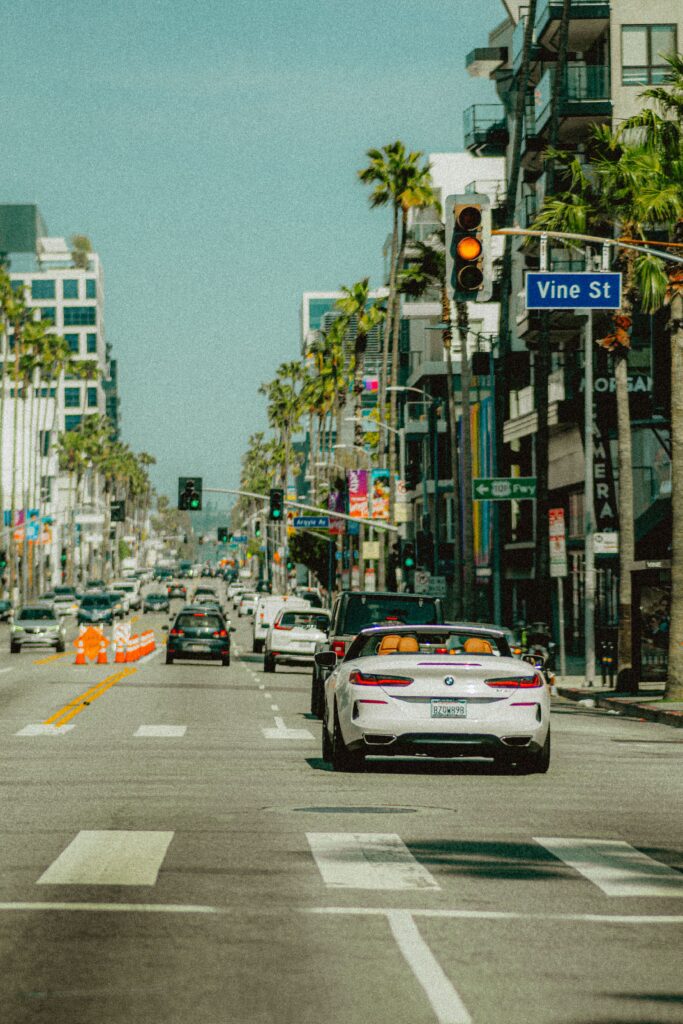 White convertible on busy palm-lined Vine Street