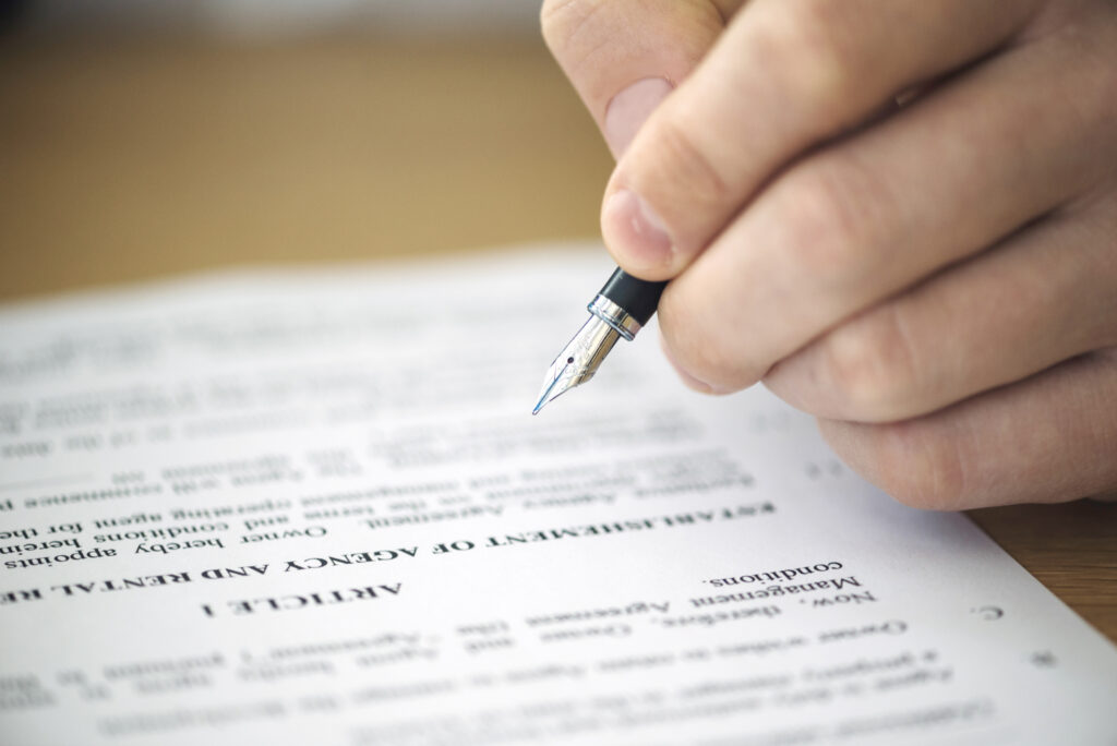 Hand signing contract with fountain pen