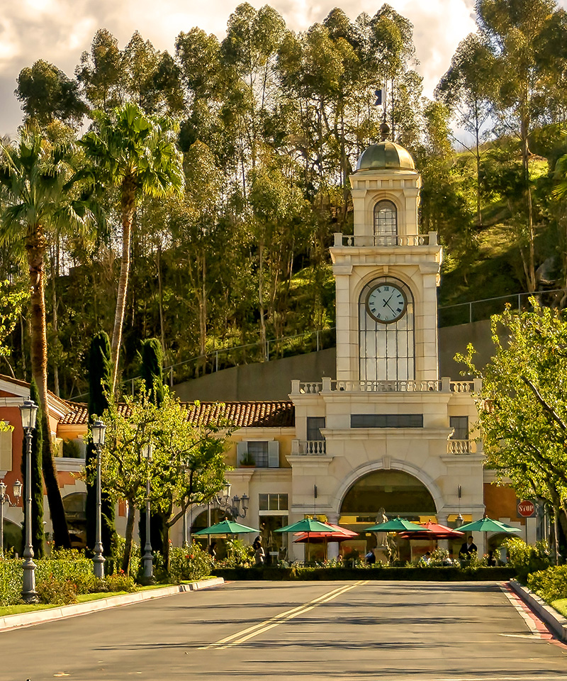 Clock tower with colorful patio umbrellas