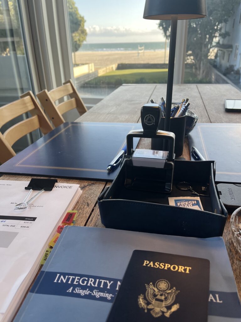 Passport and documents on desk, ocean view