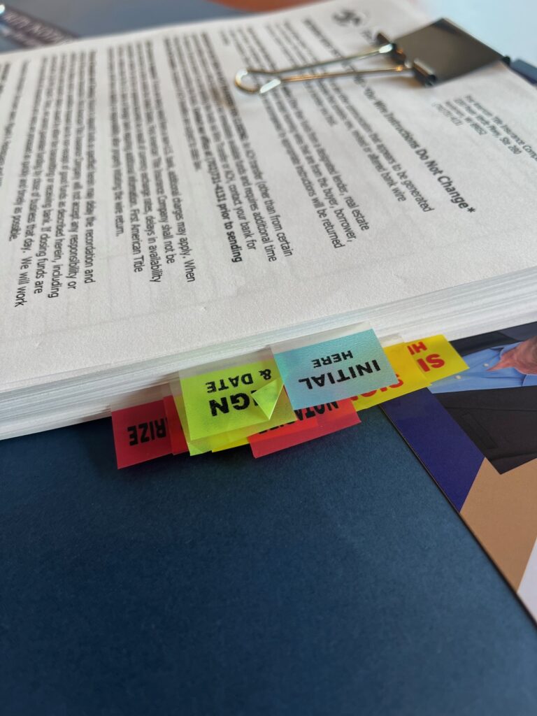Stack of documents with colorful tabbed sticky notes
