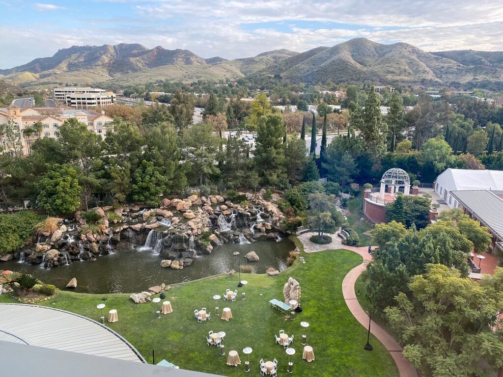 Mountain garden pond with waterfall and tables