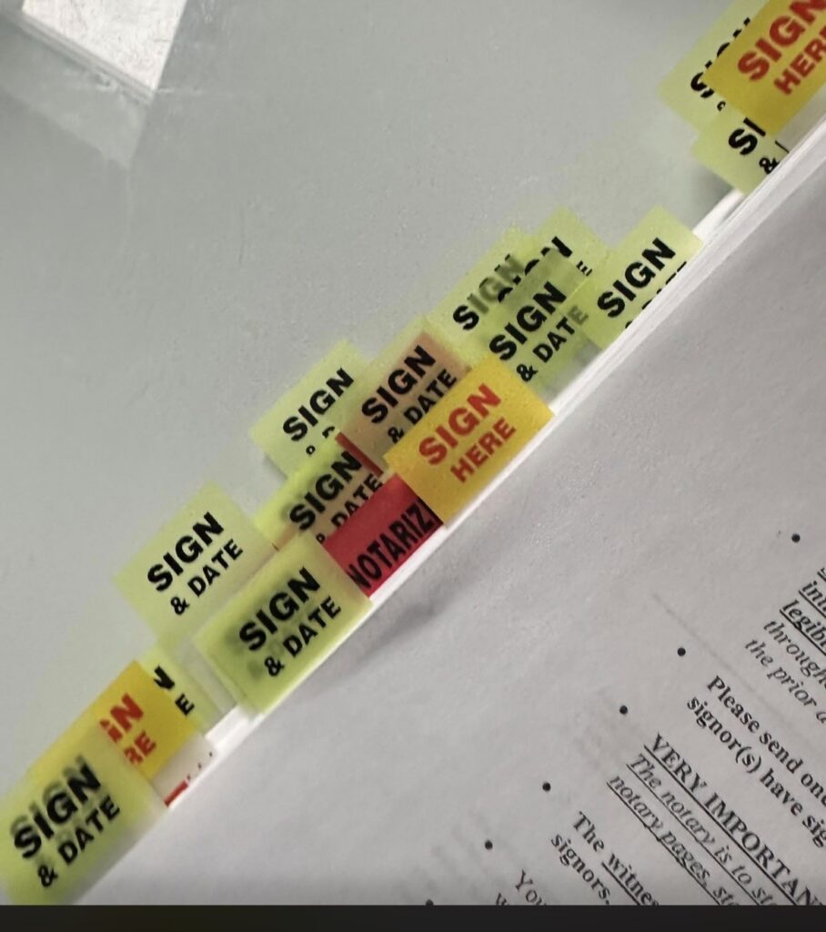 Neon "Sign & Date" sticky flags on document